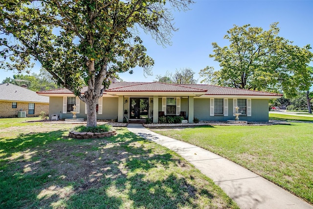 ranch-style home featuring a porch, central AC unit, and a front yard