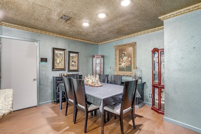 dining room featuring crown molding and hardwood / wood-style flooring