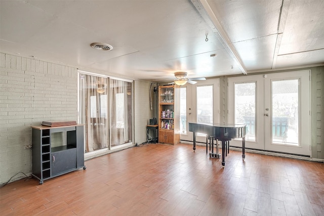 misc room featuring ceiling fan, hardwood / wood-style flooring, and french doors