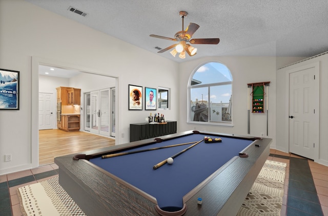 rec room featuring pool table, ceiling fan, tile patterned floors, and a textured ceiling