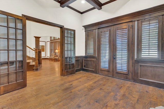 entrance foyer with beamed ceiling, french doors, hardwood / wood-style flooring, and ornamental molding