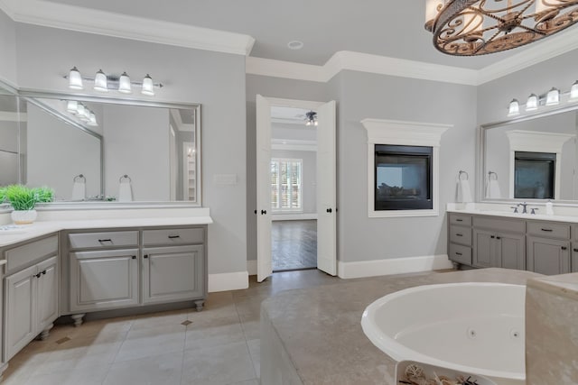 bathroom with vanity, tile patterned floors, ceiling fan, ornamental molding, and a tub