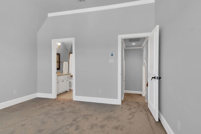 unfurnished bedroom with ensuite bathroom, light colored carpet, and ornamental molding