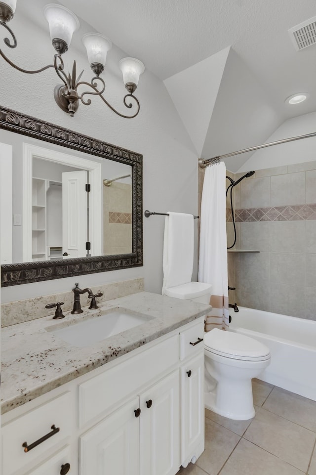 full bathroom with shower / bath combo, tile patterned floors, vanity, a textured ceiling, and toilet