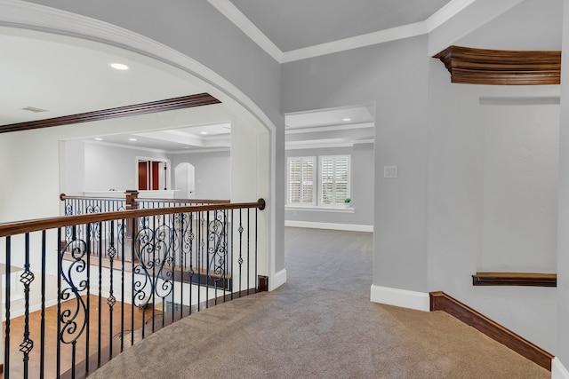 hall with carpet floors and ornamental molding