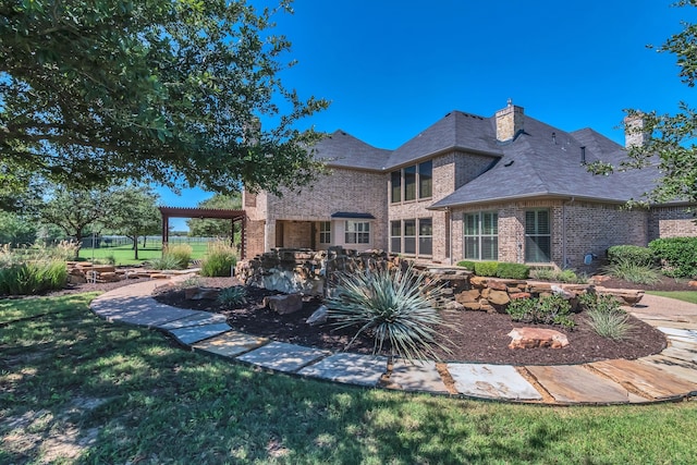 rear view of property featuring a yard