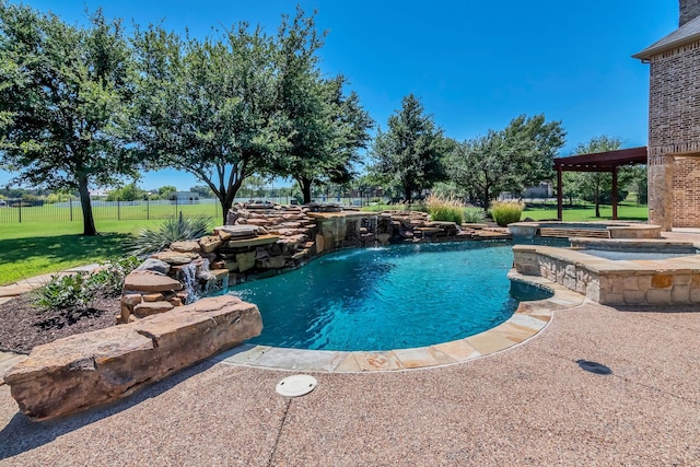 view of pool with an in ground hot tub, pool water feature, and a lawn