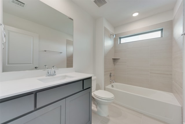 full bathroom featuring tile patterned flooring, vanity, toilet, and tiled shower / bath combo