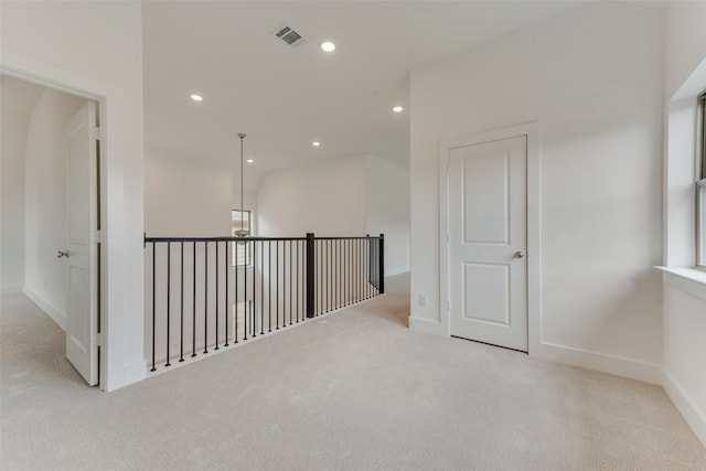 corridor featuring light colored carpet