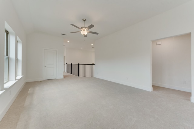 carpeted empty room featuring ceiling fan