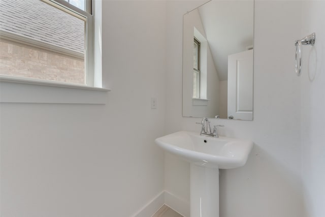 bathroom featuring lofted ceiling