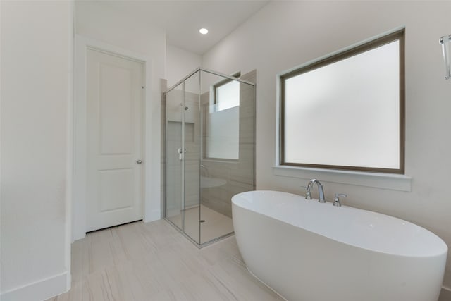 bathroom with separate shower and tub