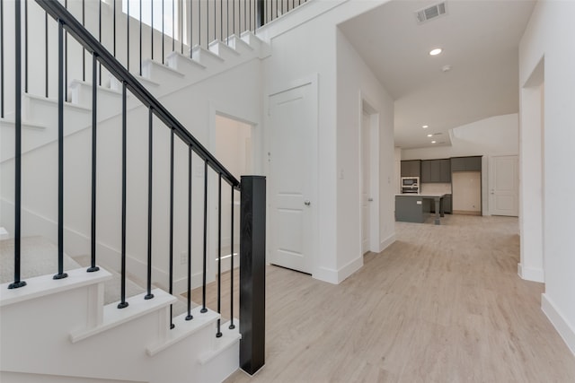 staircase with wood-type flooring