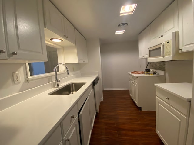 kitchen featuring dark hardwood / wood-style flooring, white cabinetry, and sink