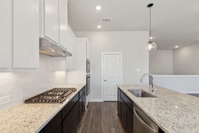 kitchen featuring visible vents, appliances with stainless steel finishes, white cabinets, a sink, and under cabinet range hood