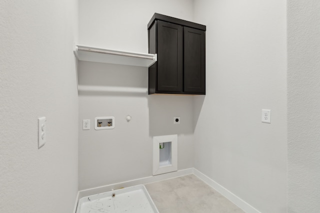 washroom featuring cabinet space, baseboards, hookup for a gas dryer, hookup for a washing machine, and hookup for an electric dryer