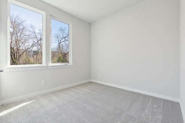 spare room with carpet and baseboards