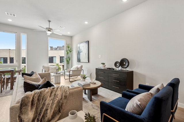 living room featuring ceiling fan and light hardwood / wood-style flooring