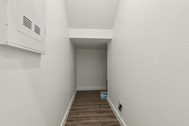 hallway featuring dark wood-style floors and baseboards