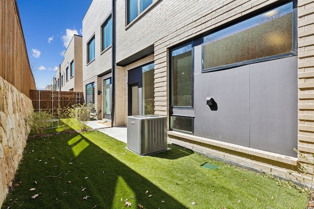 view of yard featuring cooling unit and fence