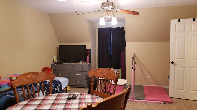 dining room featuring ceiling fan, carpet floors, and lofted ceiling