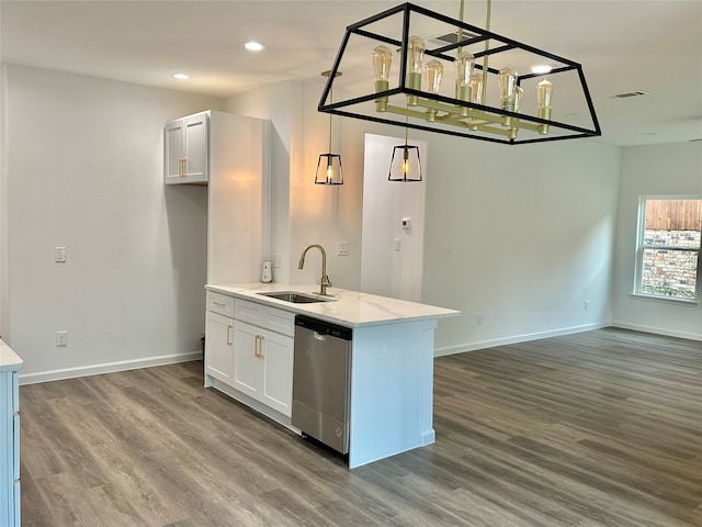 kitchen with white cabinets, hardwood / wood-style flooring, light stone counters, sink, and stainless steel dishwasher