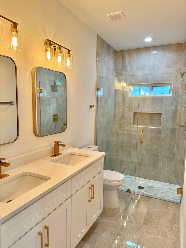 bathroom with vanity, toilet, and a shower with shower door