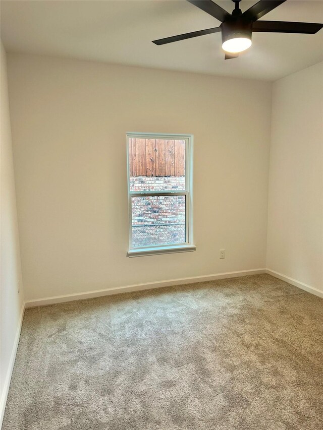 carpeted empty room featuring ceiling fan