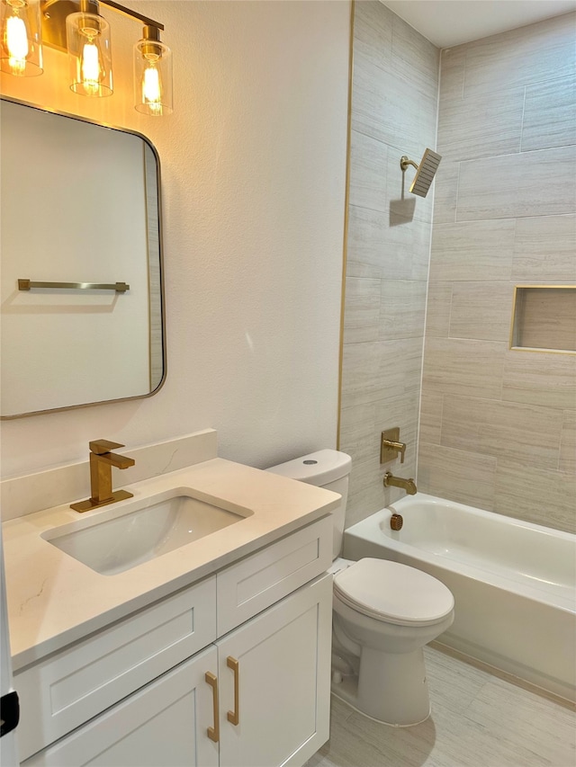 full bathroom with vanity, toilet, and tiled shower / bath