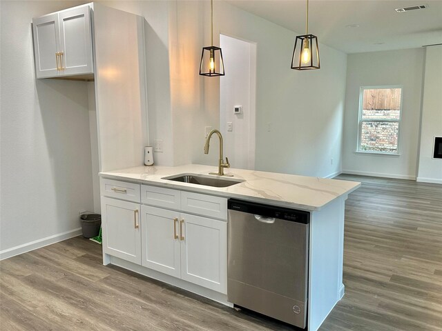 kitchen featuring white cabinets, light hardwood / wood-style flooring, stainless steel dishwasher, and sink