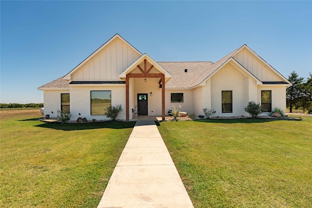 modern farmhouse with a front lawn