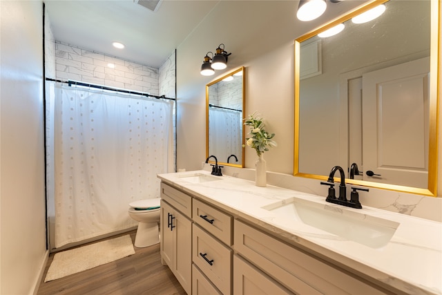 bathroom with curtained shower, toilet, hardwood / wood-style flooring, and vanity