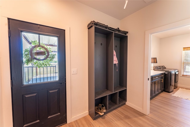 interior space with separate washer and dryer and light hardwood / wood-style floors