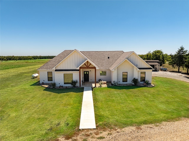 modern farmhouse style home featuring a front yard