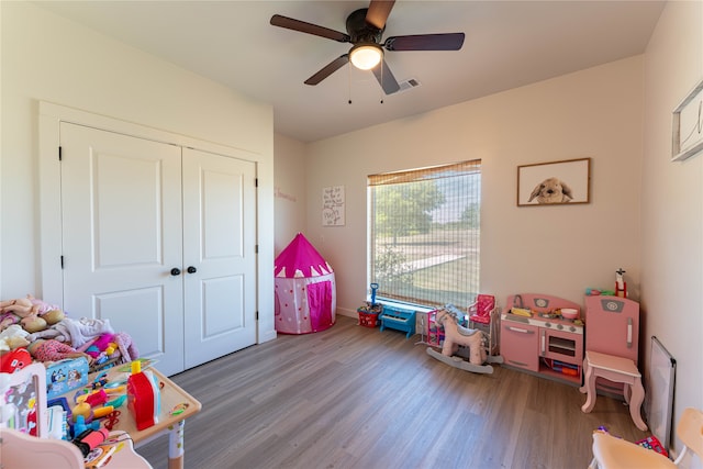 rec room with hardwood / wood-style floors and ceiling fan