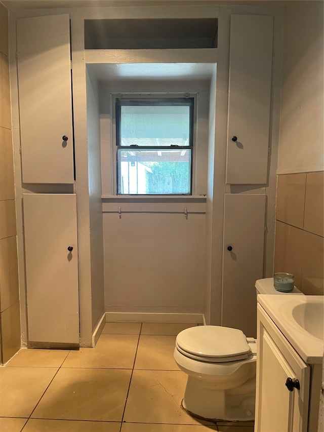 bathroom with tile patterned flooring, vanity, and toilet