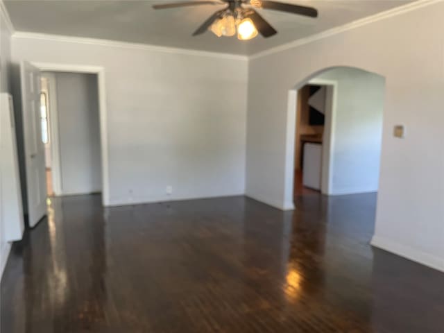 empty room with ornamental molding, ceiling fan, and dark hardwood / wood-style floors