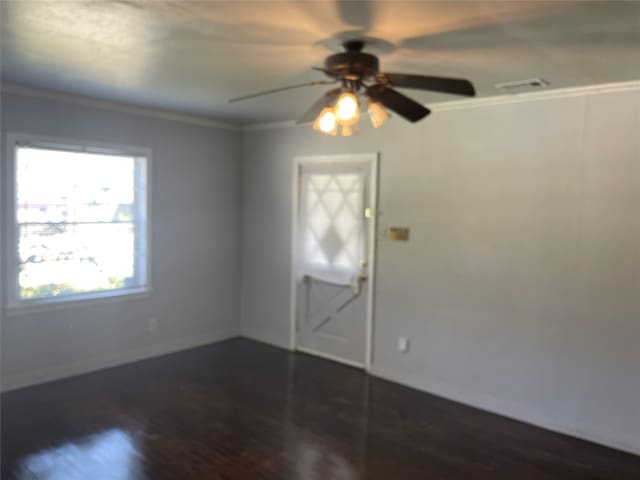 unfurnished room with ceiling fan, dark hardwood / wood-style floors, and ornamental molding