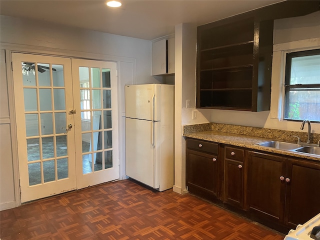 kitchen with french doors, white refrigerator, sink, dark parquet floors, and ceiling fan