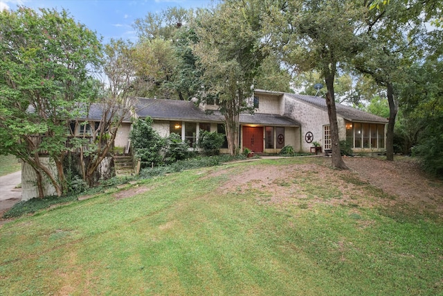 view of front of house featuring a front yard and a sunroom