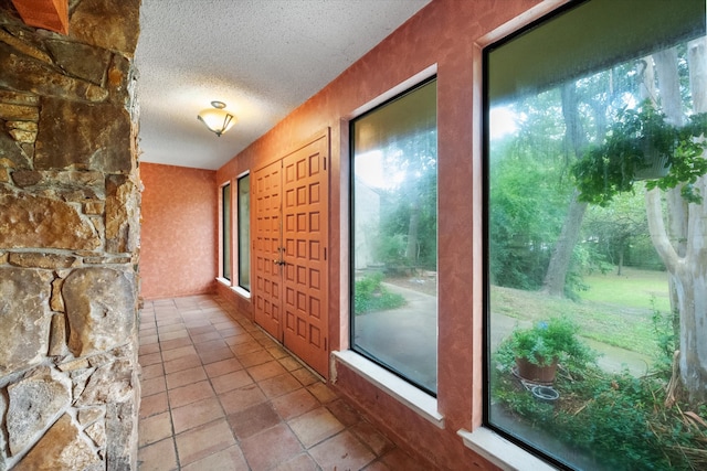 corridor with a textured ceiling