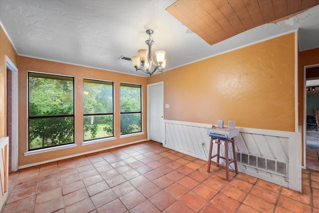 unfurnished room featuring a wealth of natural light, a chandelier, and tile patterned flooring