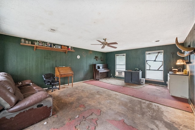 unfurnished living room featuring a textured ceiling, concrete floors, and ceiling fan