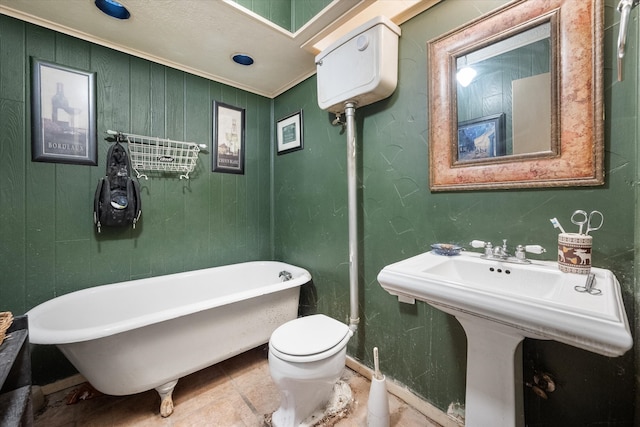 bathroom with a tub, toilet, and crown molding