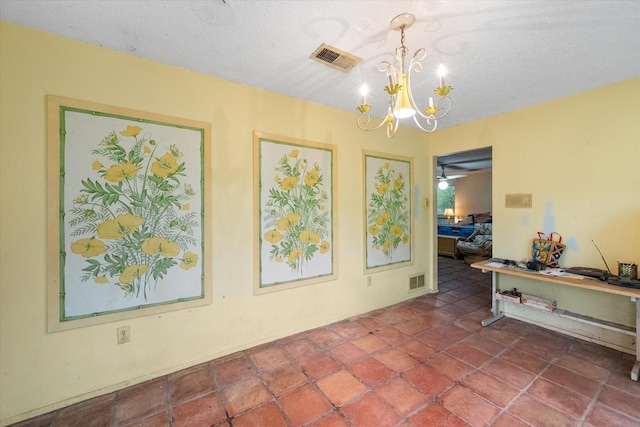 interior space with ceiling fan with notable chandelier and a textured ceiling