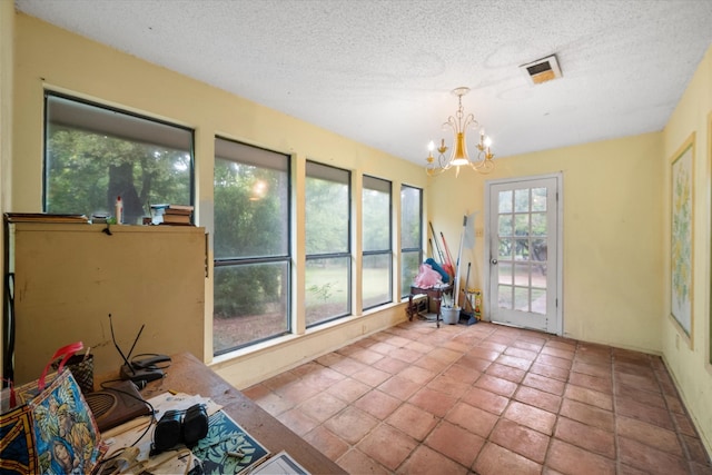 unfurnished sunroom with a notable chandelier