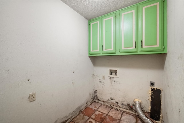 washroom featuring hookup for a washing machine, cabinets, electric dryer hookup, and a textured ceiling