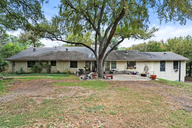 rear view of house featuring a lawn and a patio area