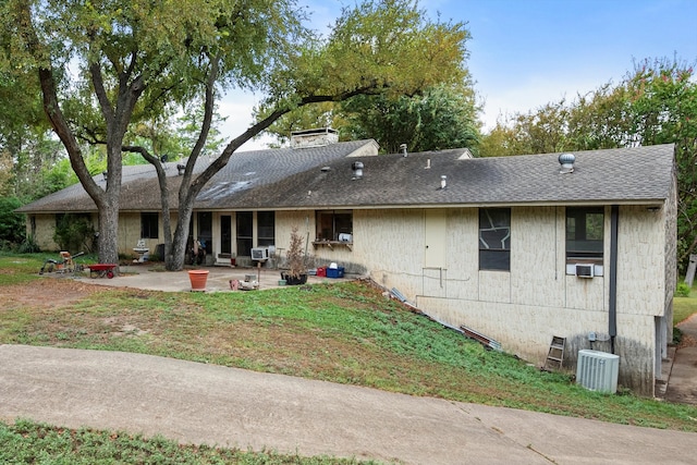 rear view of house featuring central AC unit, a patio area, and cooling unit