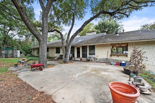 rear view of house featuring cooling unit and a patio